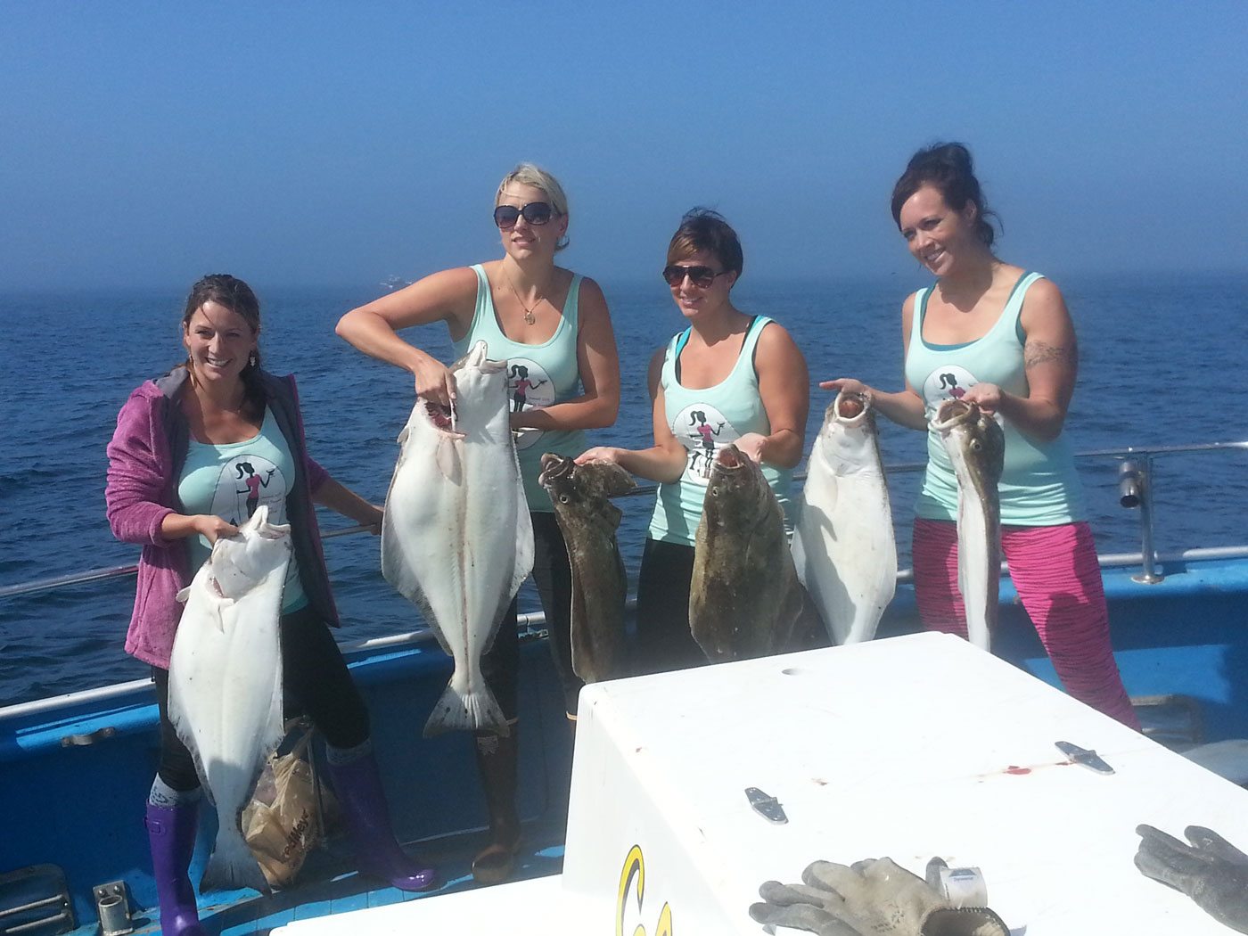 four women holding fish in Ninilchik