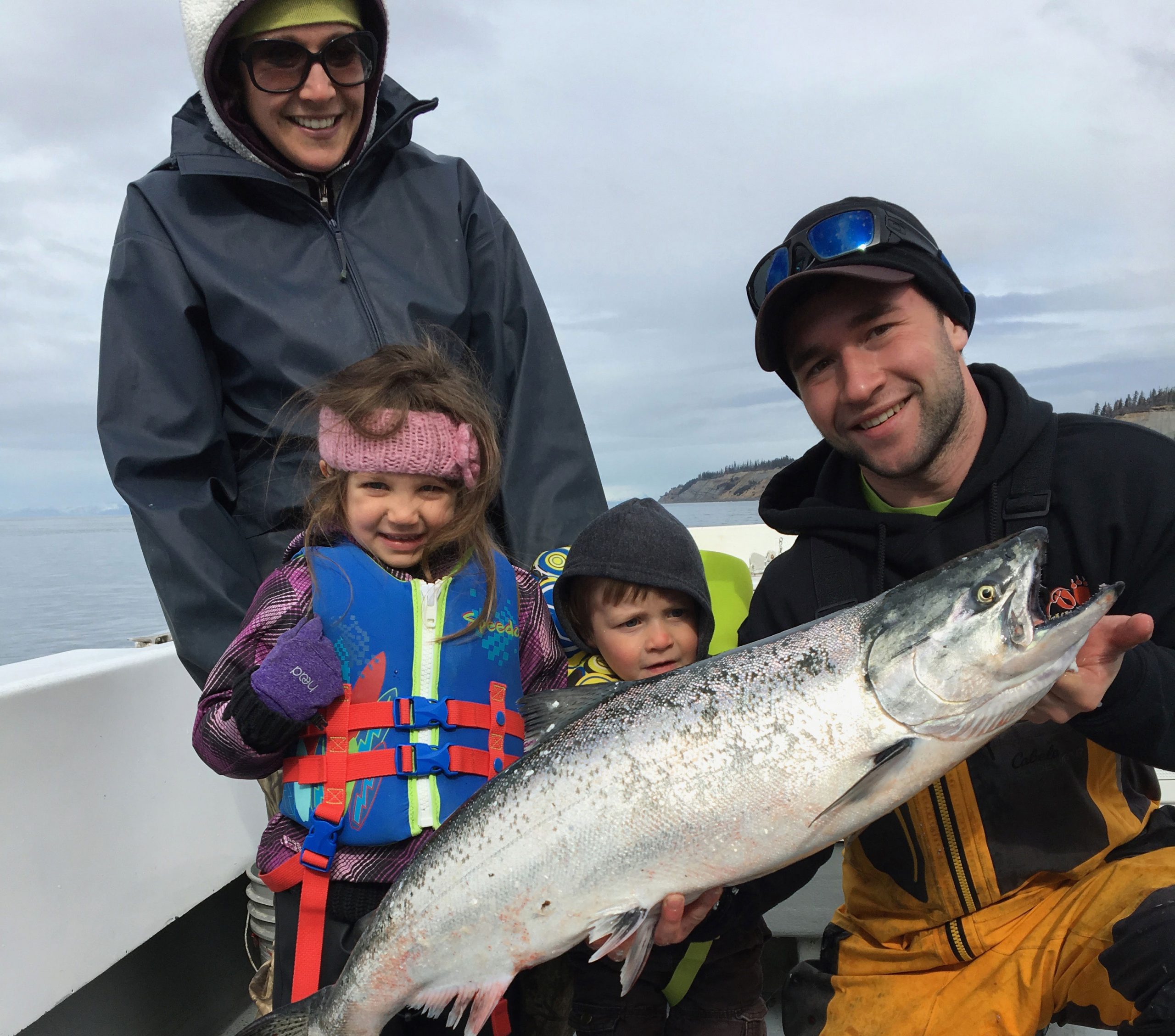 Kids holding salmon in Alaska